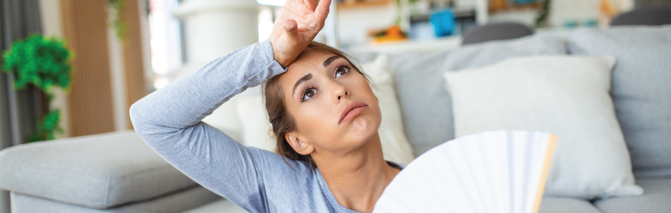 women feeling frustrated by HVAC with hand against forehead