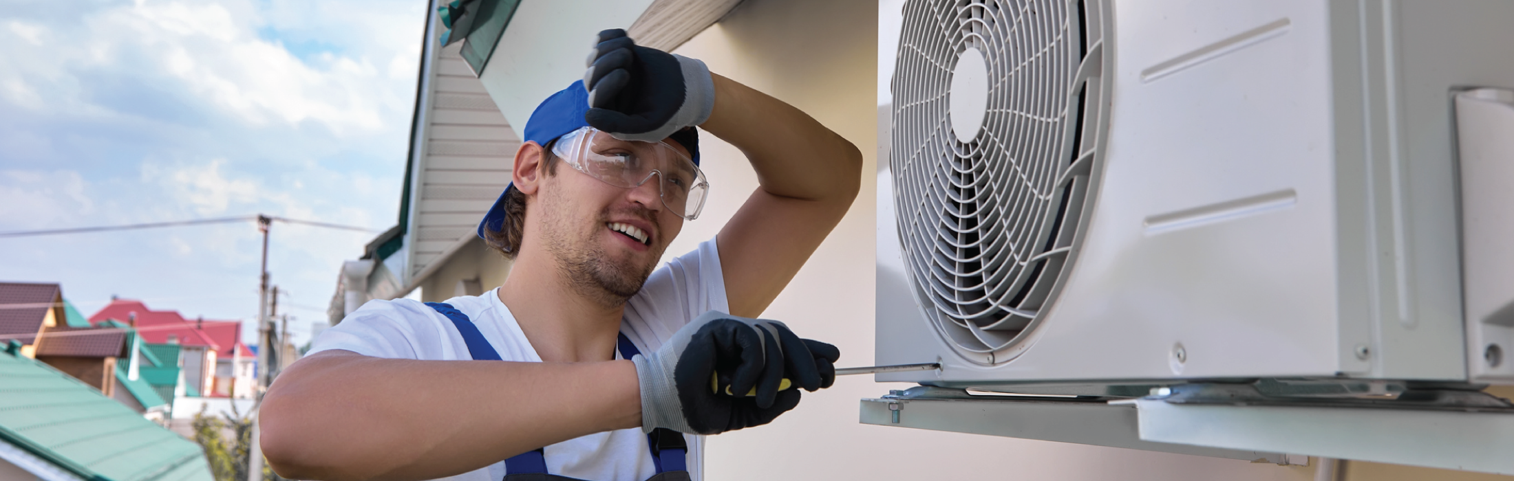 Man fixing HVAC unit that has broken in the heat